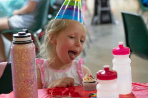 Blair Kay eats a cupcake at CampCare 2021.