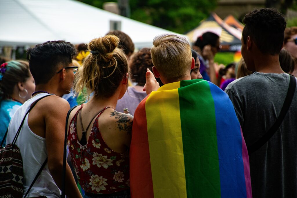 Freinds stand together at a Pride parade. Cancer in the LGBTQIA+ community has its own challenges.