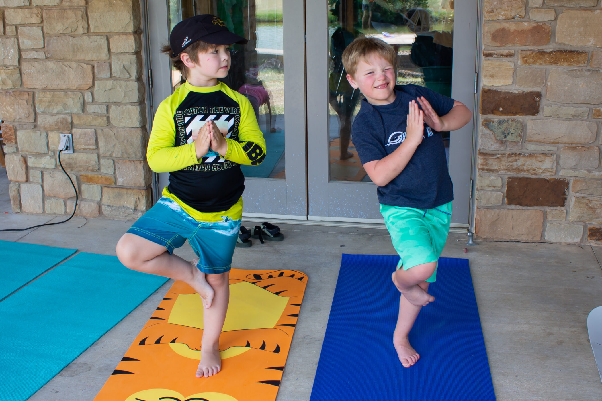 Leo and his cousin particpate in yoga at CampCARE 2022.