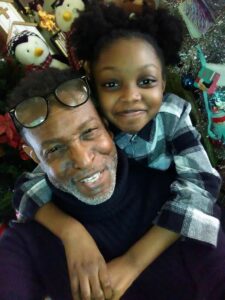 Darion and his daughter, mentioned in Darion's Story, take a seflie.