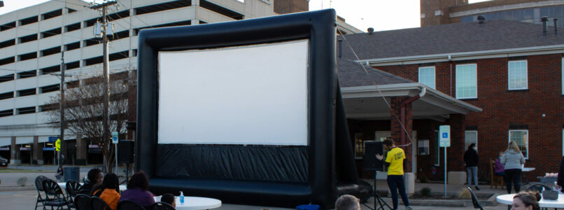 Clients attend an outdoor movie screening for the March Connect Night at Cancer Care Services.