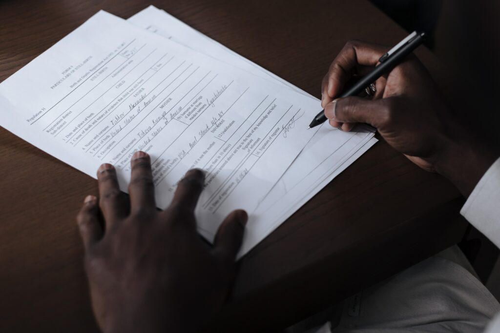 A person signs a document that they downloaded from Care and Prepare.