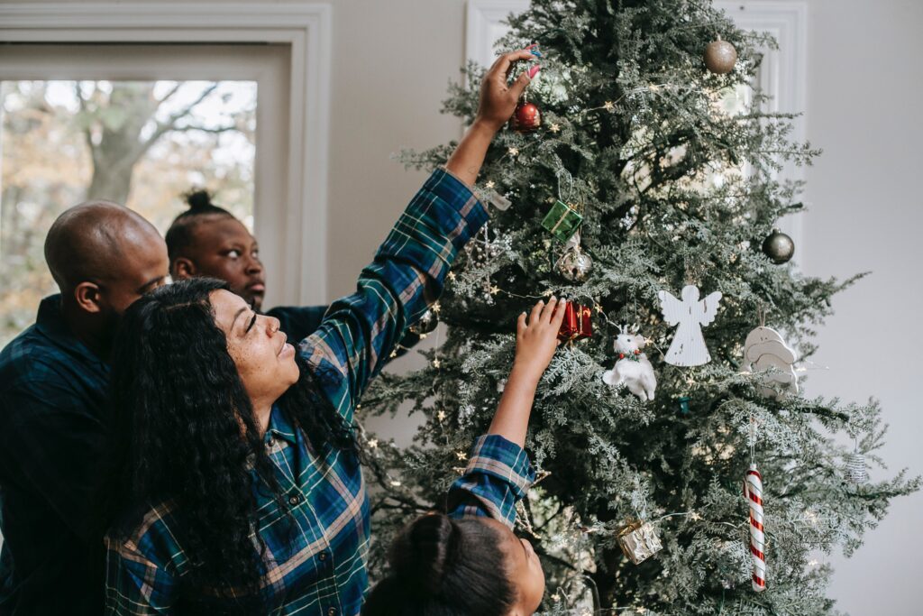 A family decorates a tree to help a caregiver manage through the holidays.