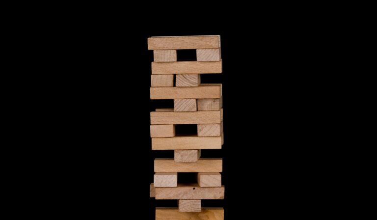 A Jenga tower with missing pieces represents the impact of a social worker.