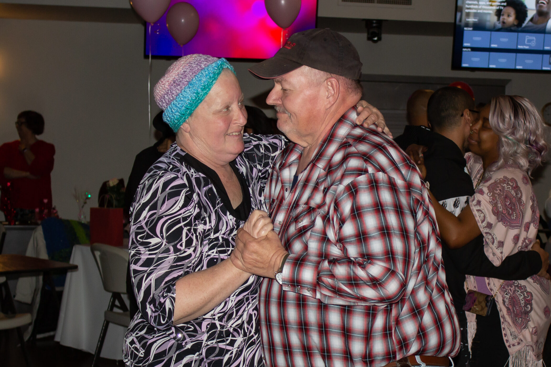 A couple dances at a Connect Night: Valentine's Dinner hosted by Cancer CareServices.