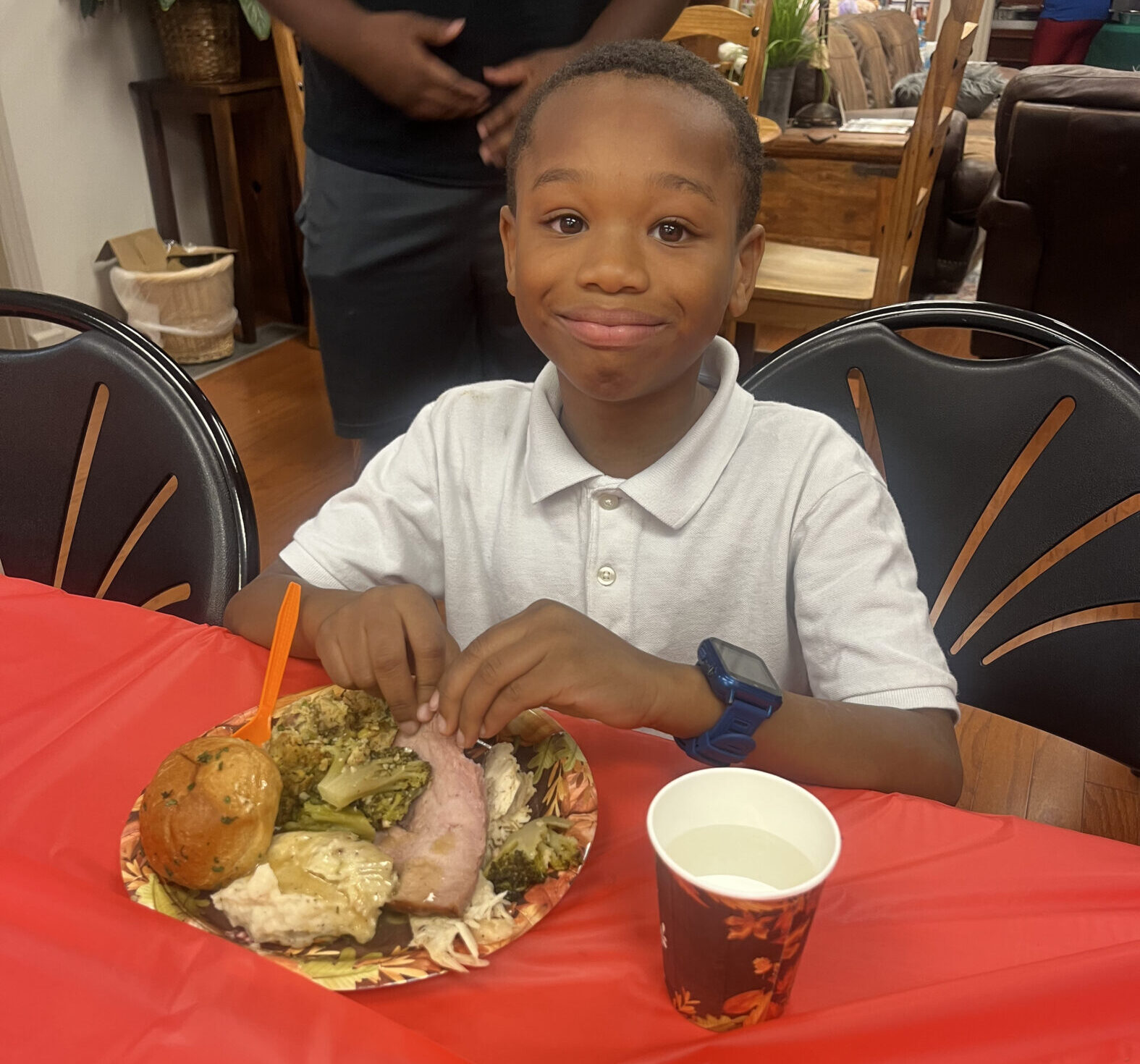 A boy has a full plate of food at Friendsgiving hosted by Cancer Care Services.